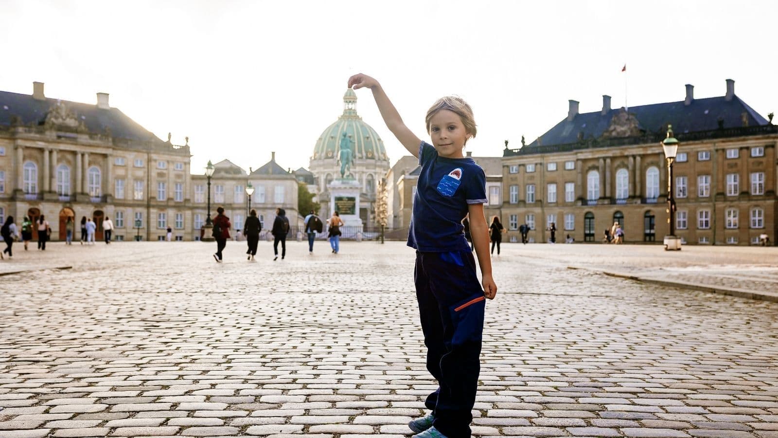 Little boy in the middle of Amalienborg square posing for the camera